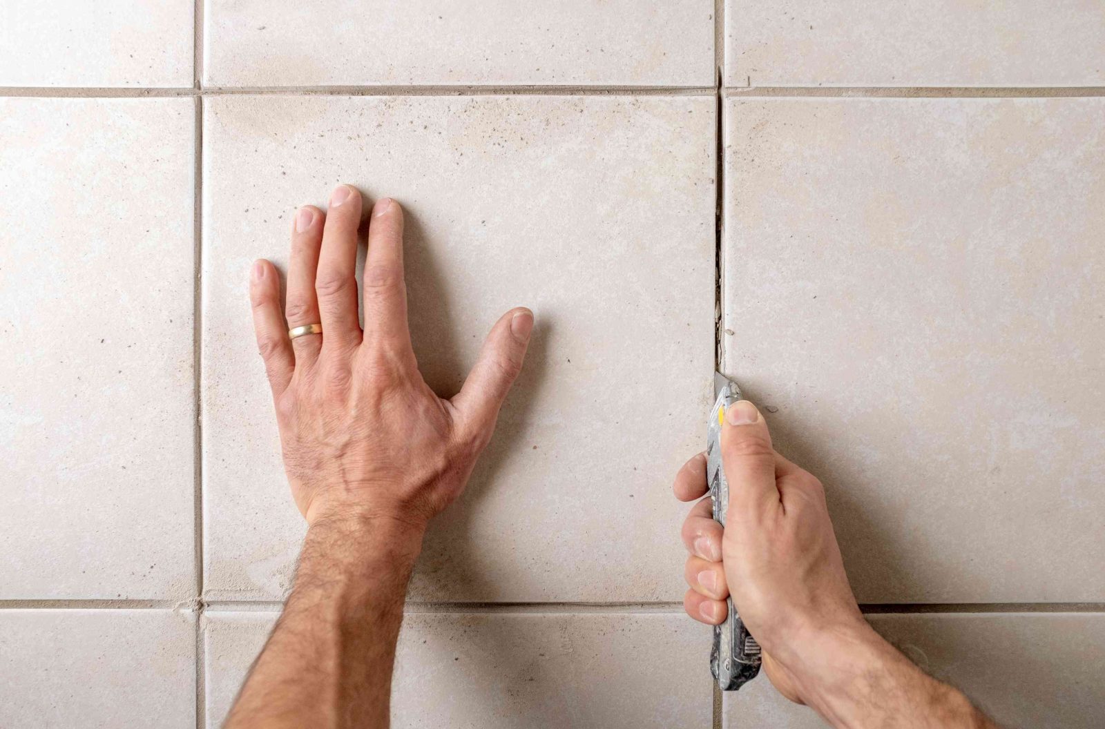 man cleans tiles 